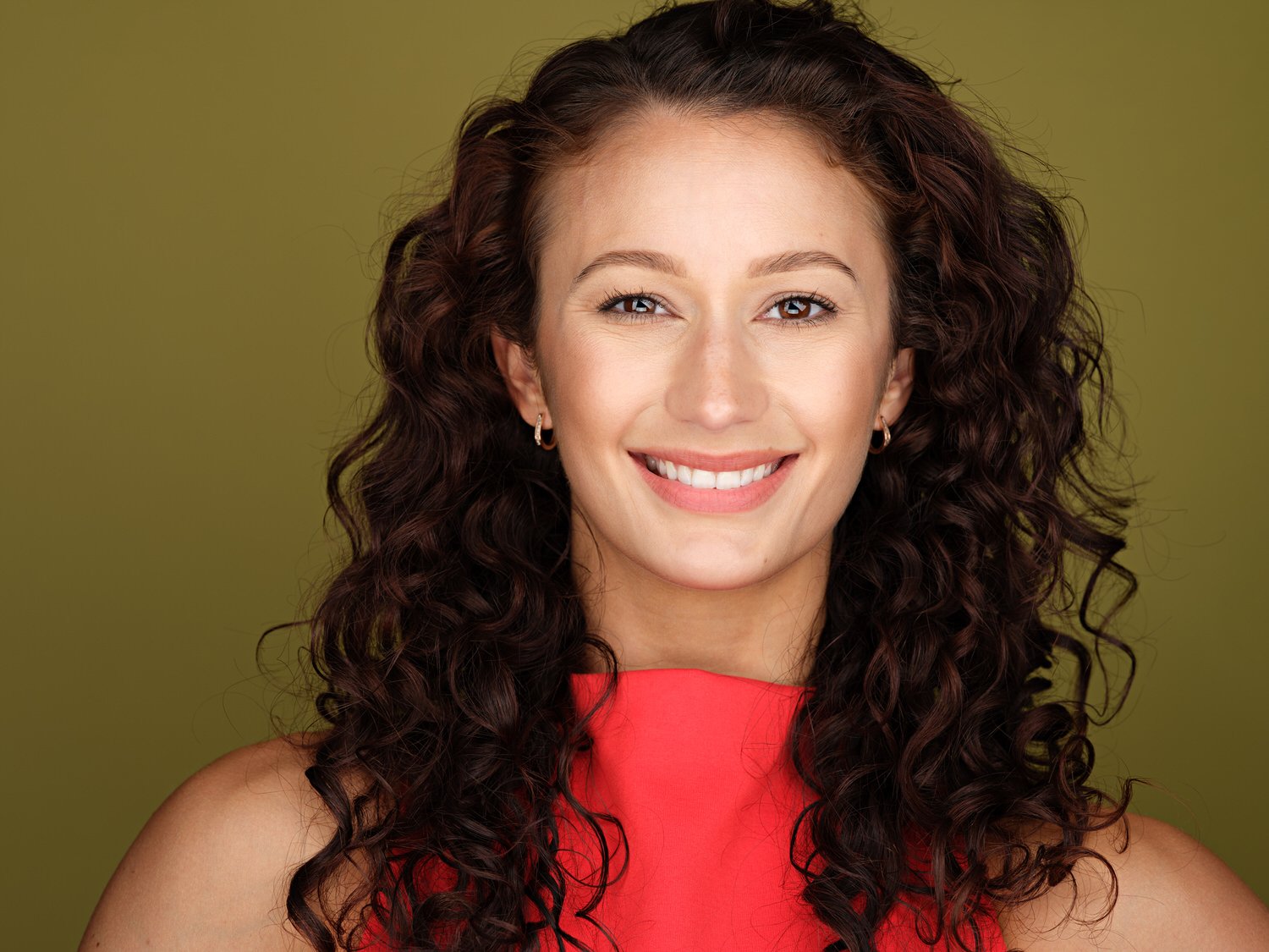 Headshot of a model in yellow backdrop