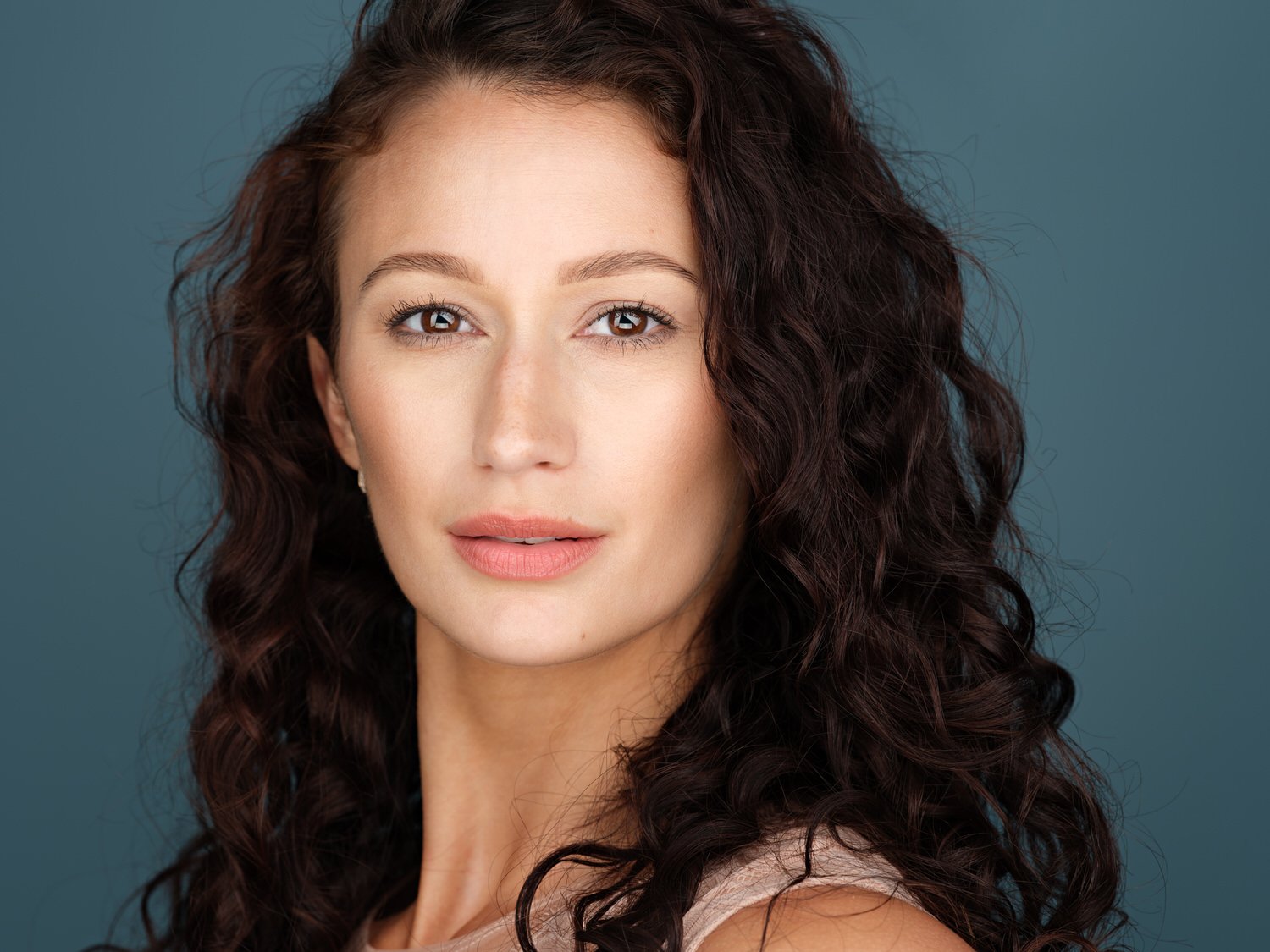 Headshot of a model in blue backdrop