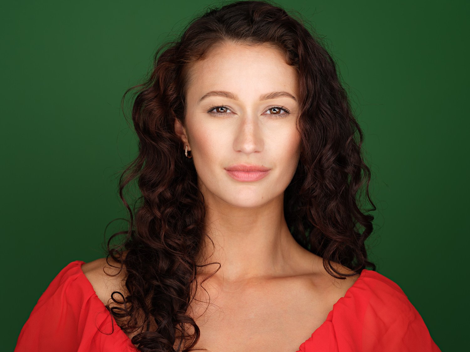 Headshot of a model in light green backdrop