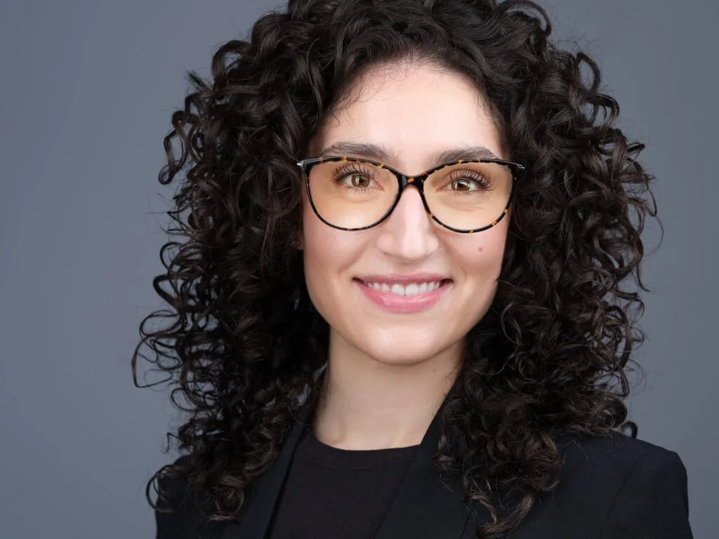Corporate headshot of a woman in glasses and a black blazer, Toronto studio