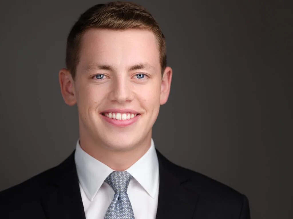 Corporate headshot of a man in a dark suit and light tie, Toronto business headshot