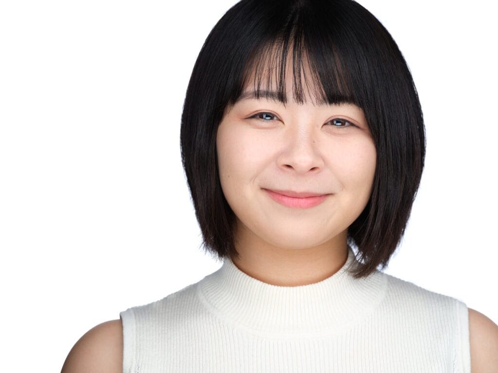 Commercial actor headshot of a woman with a short bob in a light top, Toronto studio