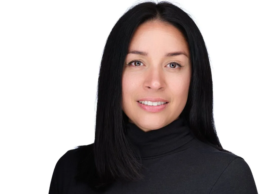 Corporate headshot of a woman in a black turtleneck on a white background, Toronto studio