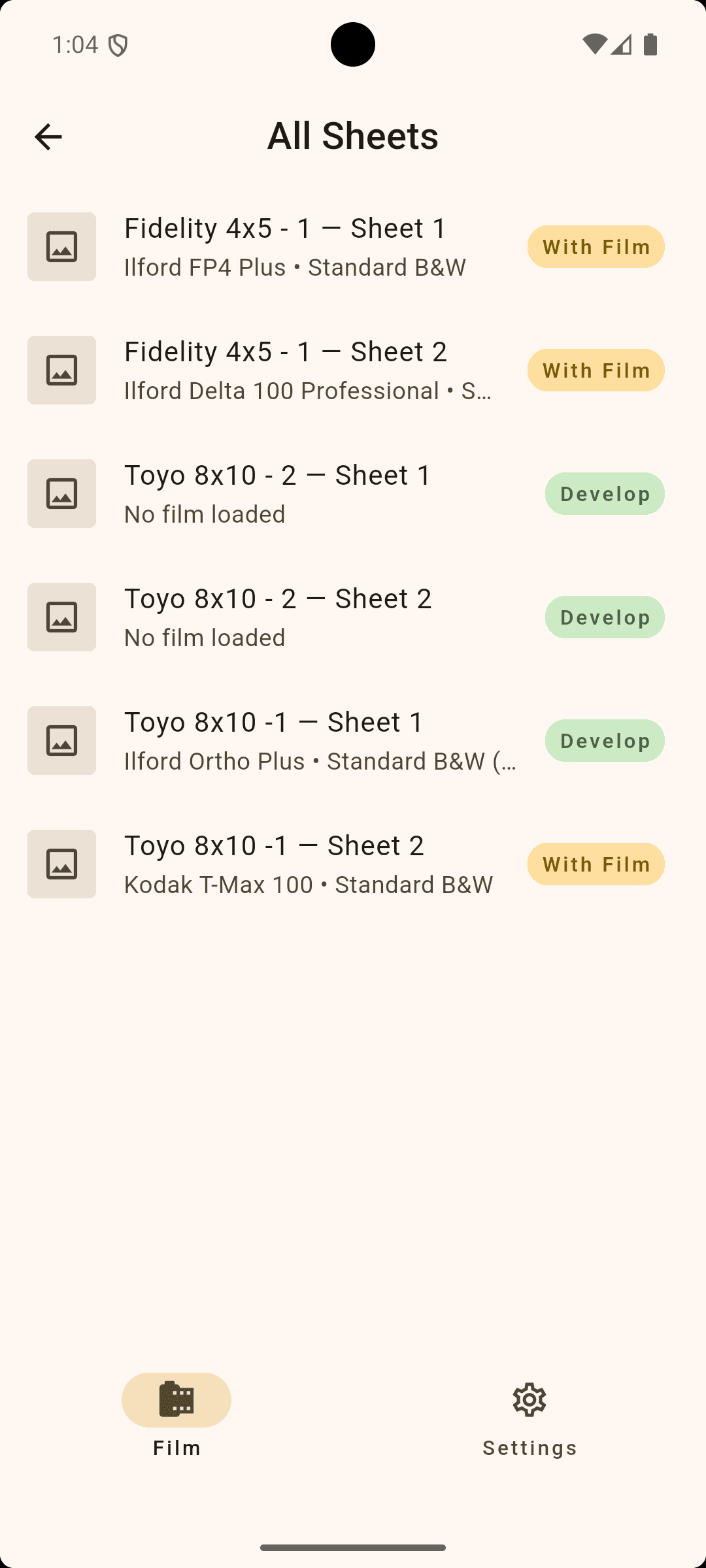A mobile phone screen showing a list of film sheets with various labels and statuses, like 'With Film' and 'Develop', under the 'All Sheets' section, with navigation icons at the bottom for 'Film' and 'Settings.'