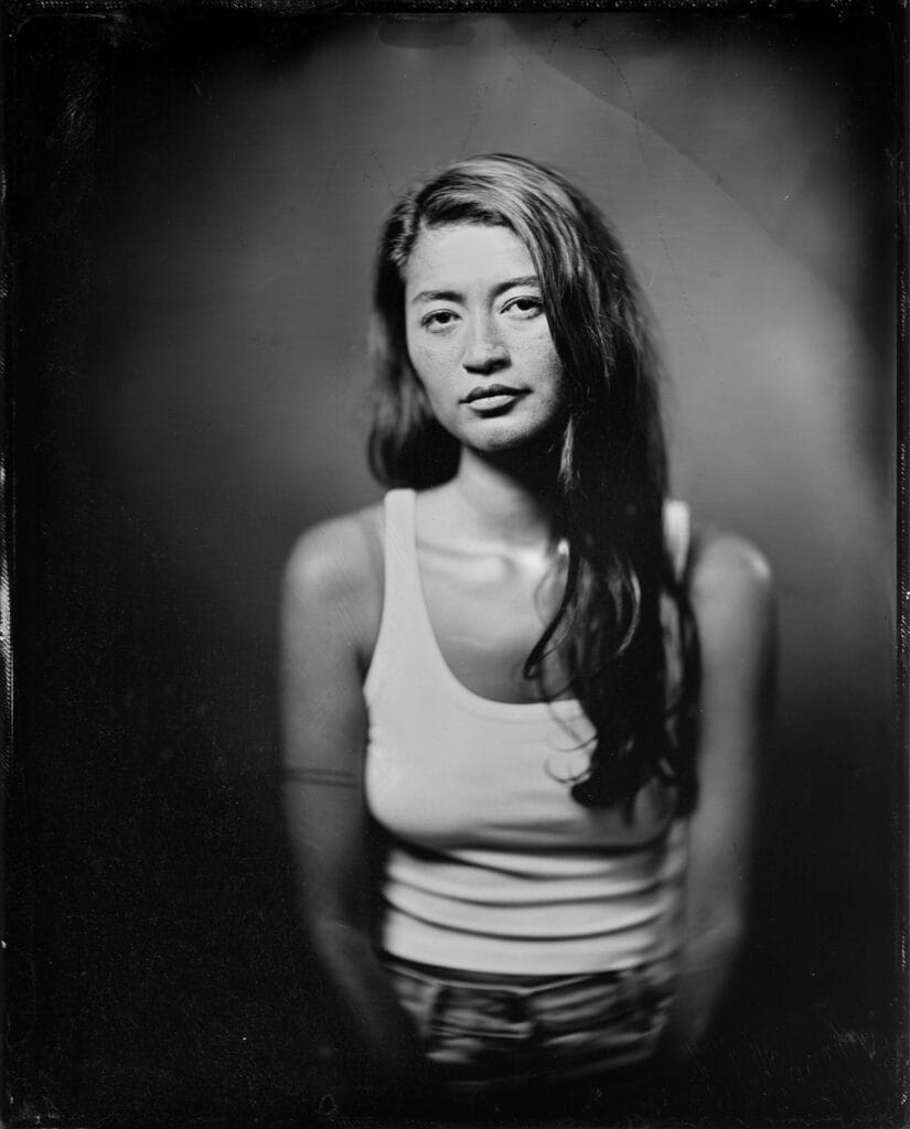 Wet plate collodion tintype portrait of a young woman with long dark hair, hand-poured 8x10 plate made in a Toronto studio